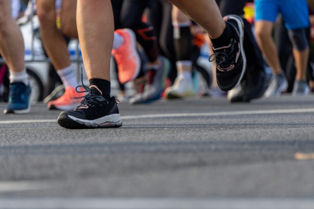 Dynamic shot capturing feet in a marathon, showcasing motion and determination.