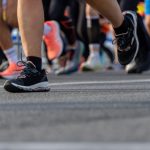 Dynamic shot capturing feet in a marathon, showcasing motion and determination.